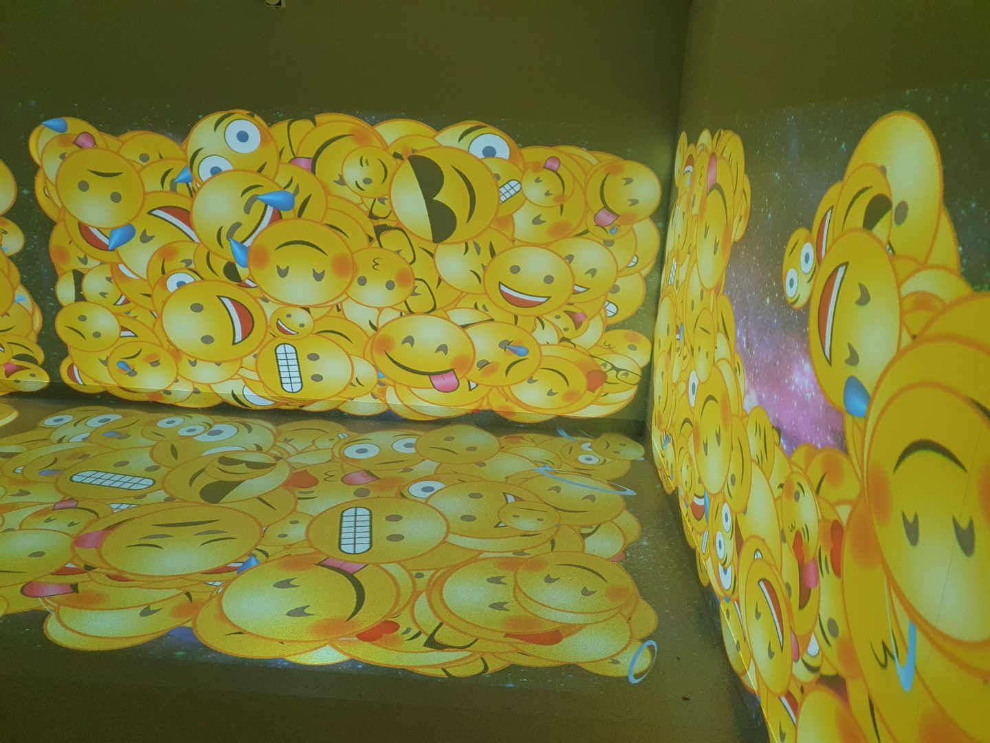 fully interactive immersive room including 2 interactive walls and 1 interactive floor. displaying the emoji scatter activity to enhance sensory stimulation