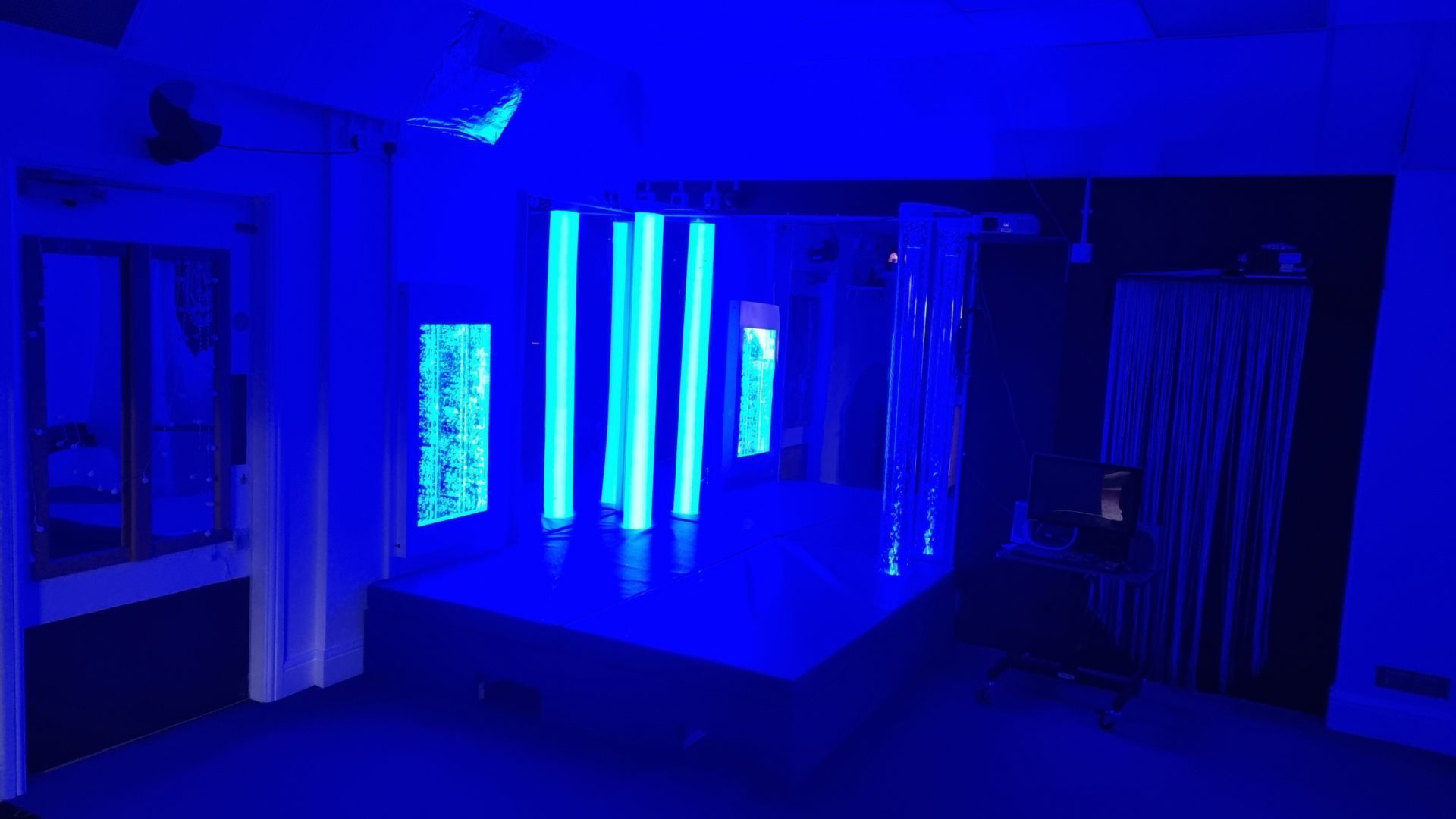 interactive light tube and bubble wall in a dark room to enhance sensory stimulation
