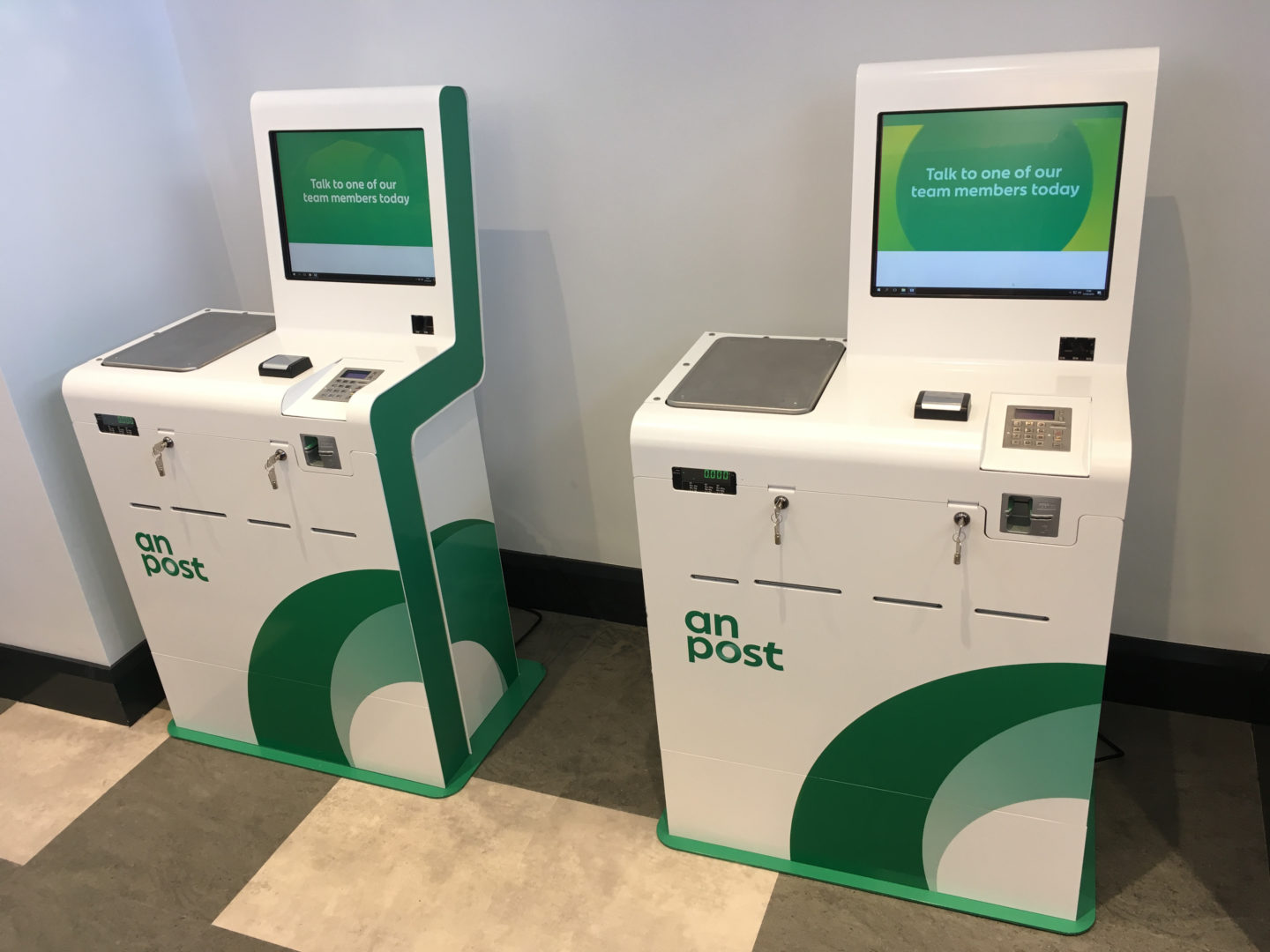 green and white smart postal kiosks with integrated scale allowing bill payments and stamp printing onto various size stamps designed for pick up and drop off (PUDO)