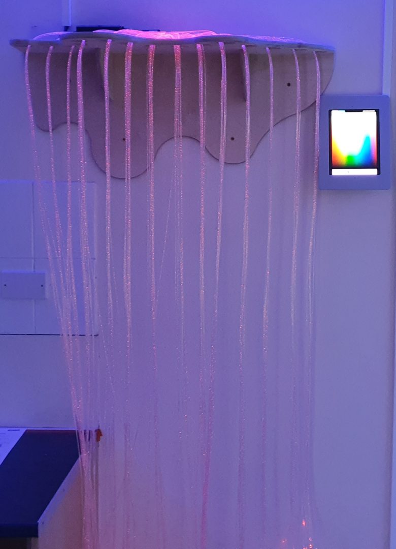 RGB fibre optic stands cascading over a shelf controlled by a wall mounted ipad and the imaginate app