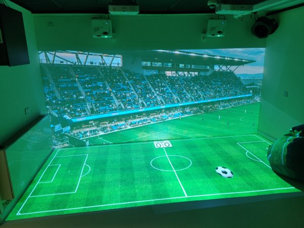 fully interactive edge blended immersive room including 2 interactive walls, 2 interactive floors and a range of DMX sensory stimulation hardware, projecting a football stadium and match