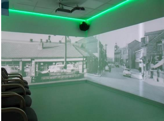 fully interactive immersive room including 4 interactive walls and a range of DMX sensory effect hardware. displaying a street from the past
