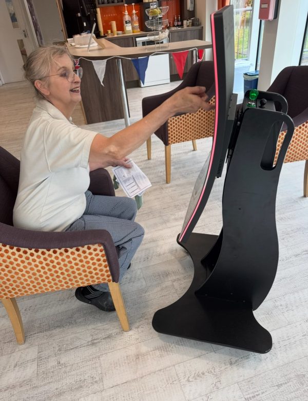 lady sat in the chair using an interactive screen